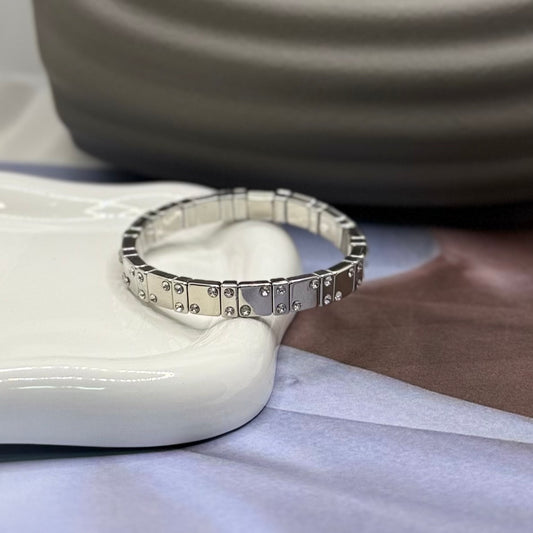 PULSERA RESORTE PLATEADA CON PIEDRA BLANCA