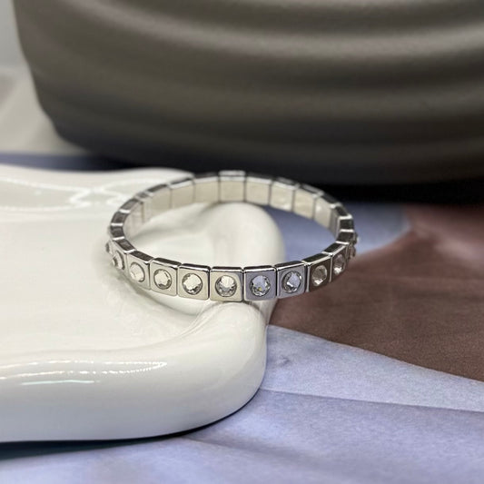 PULSERA RESORTE PLATEADA CON PIEDRA GRANDE BLANCA